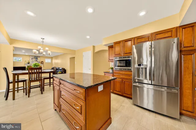 a dining room filled with lots of furniture and kitchen view