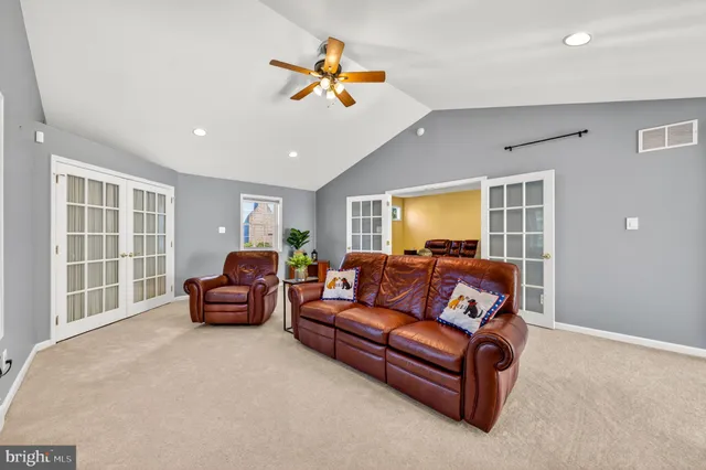 a bedroom with a bed and a walk in closet with wooden floor