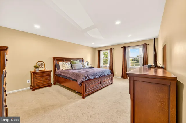 a bathroom with a granite countertop sink mirror vanity and toilet