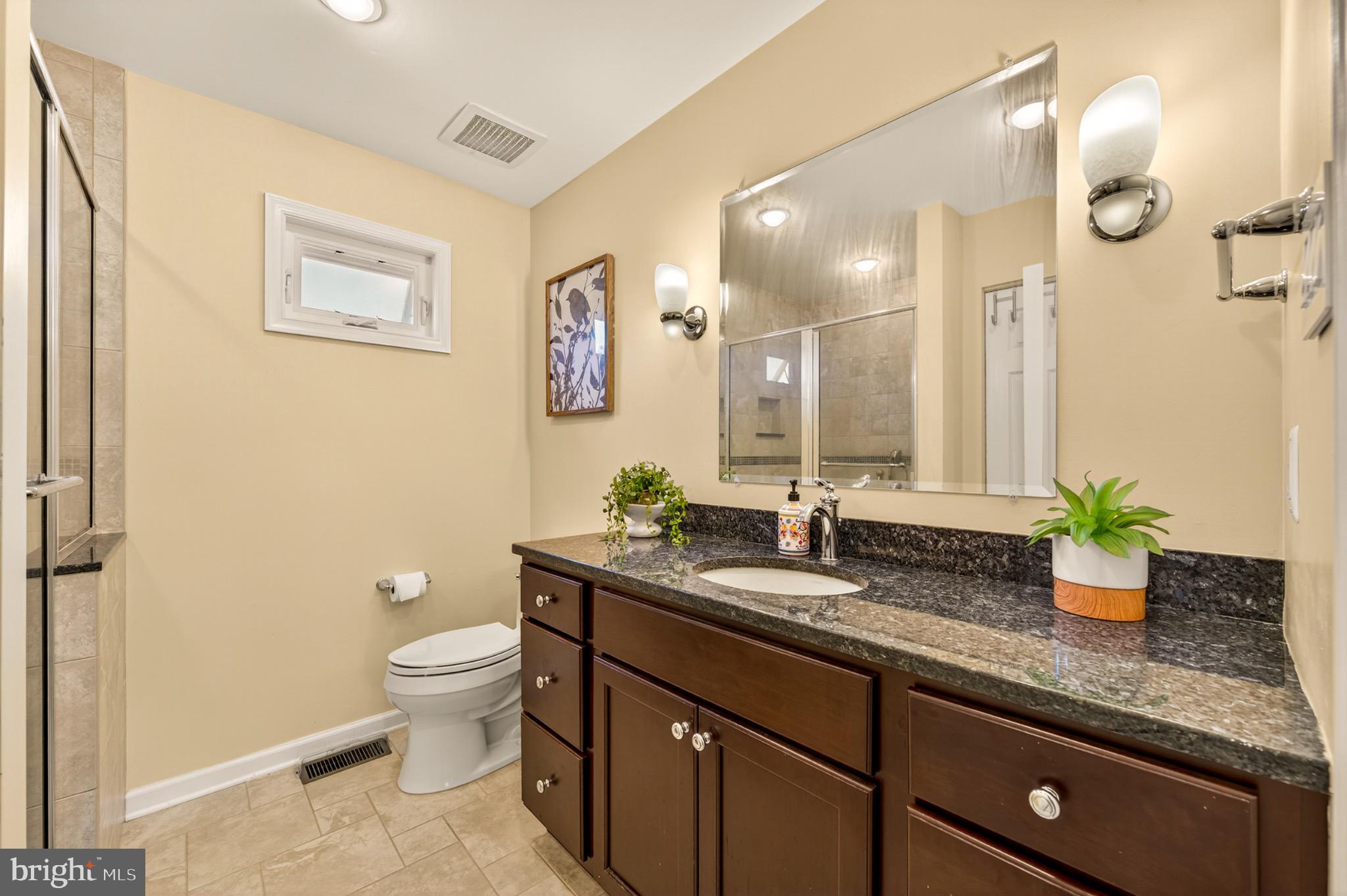 1520 Fairgrounds Road Hatfield, PA 19440 - Photo 39 of 52 a bathroom with a granite countertop sink mirror vanity and toilet