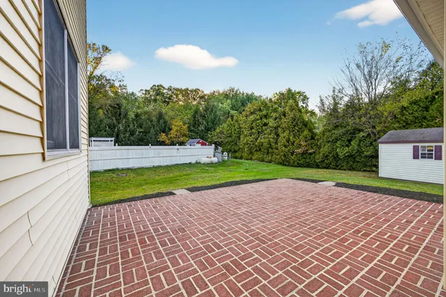 a view of a backyard with plants and a garden