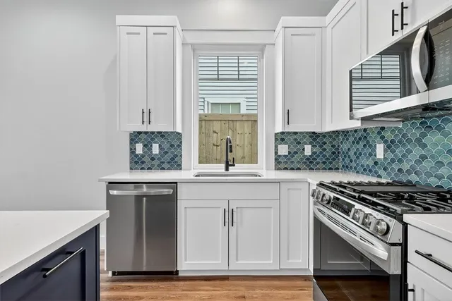 a kitchen with a refrigerator sink and stove
