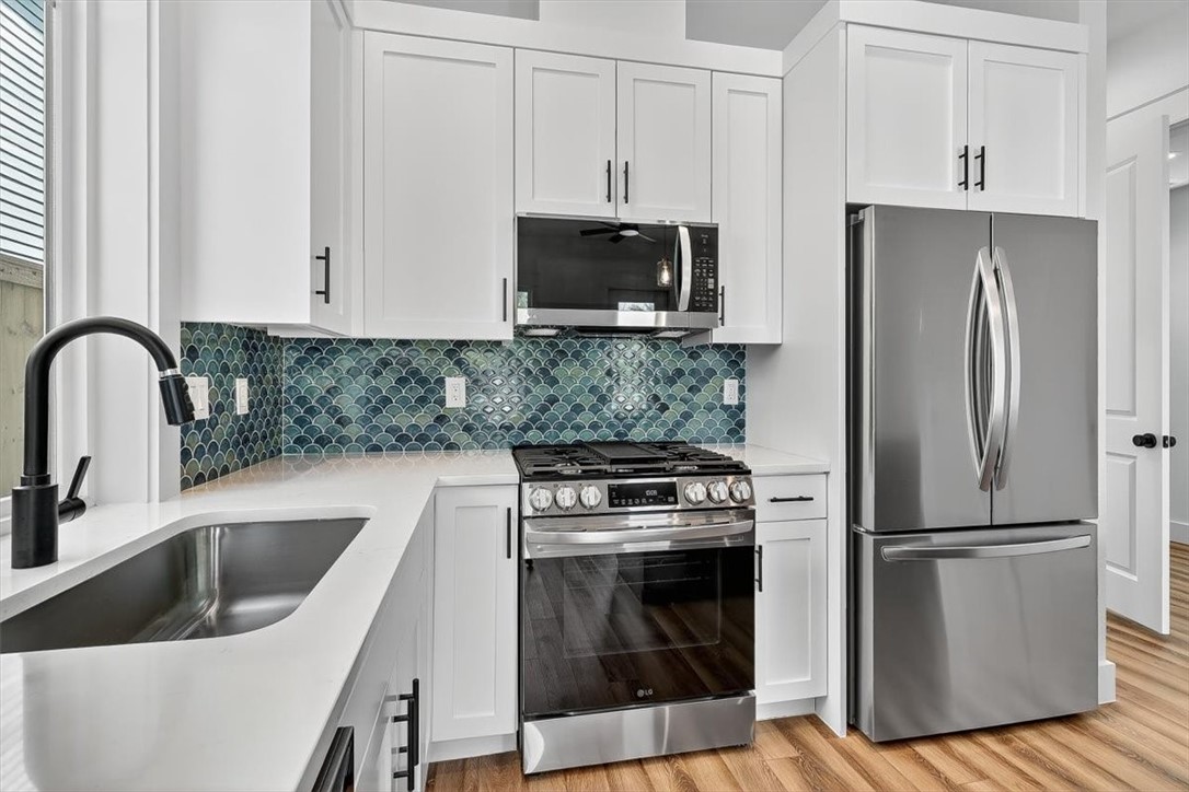 232 Nautilus Port Aransas, TX 78373 - Photo 12 of 28 a kitchen with a refrigerator sink and stove