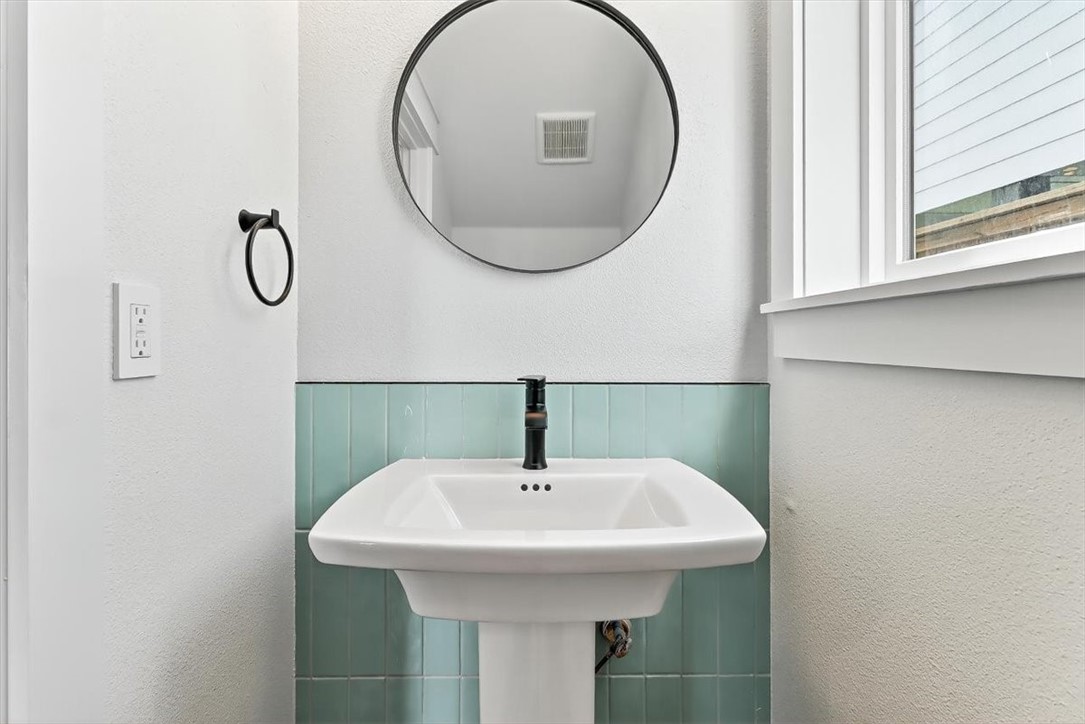 232 Nautilus Port Aransas, TX 78373 - Photo 14 of 28 a bathroom with a sink and a mirror