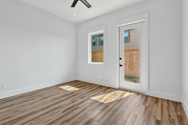 a view of wooden floor and an entryway in a room