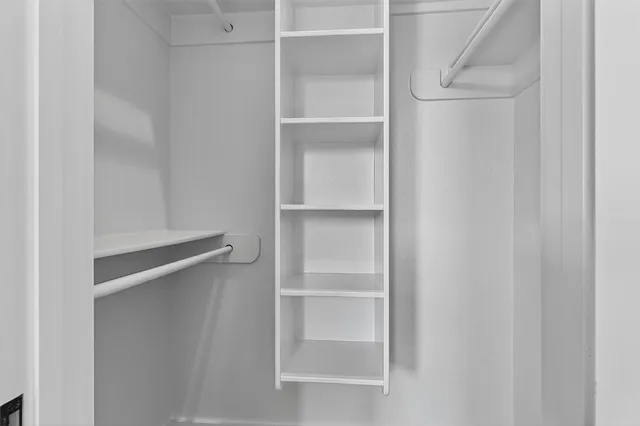 a bathroom with a sink vanity mirror and toilet