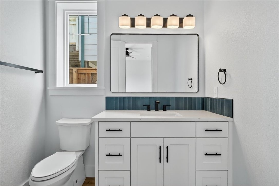 232 Nautilus Port Aransas, TX 78373 - Photo 21 of 28 a bathroom with a sink vanity mirror and toilet