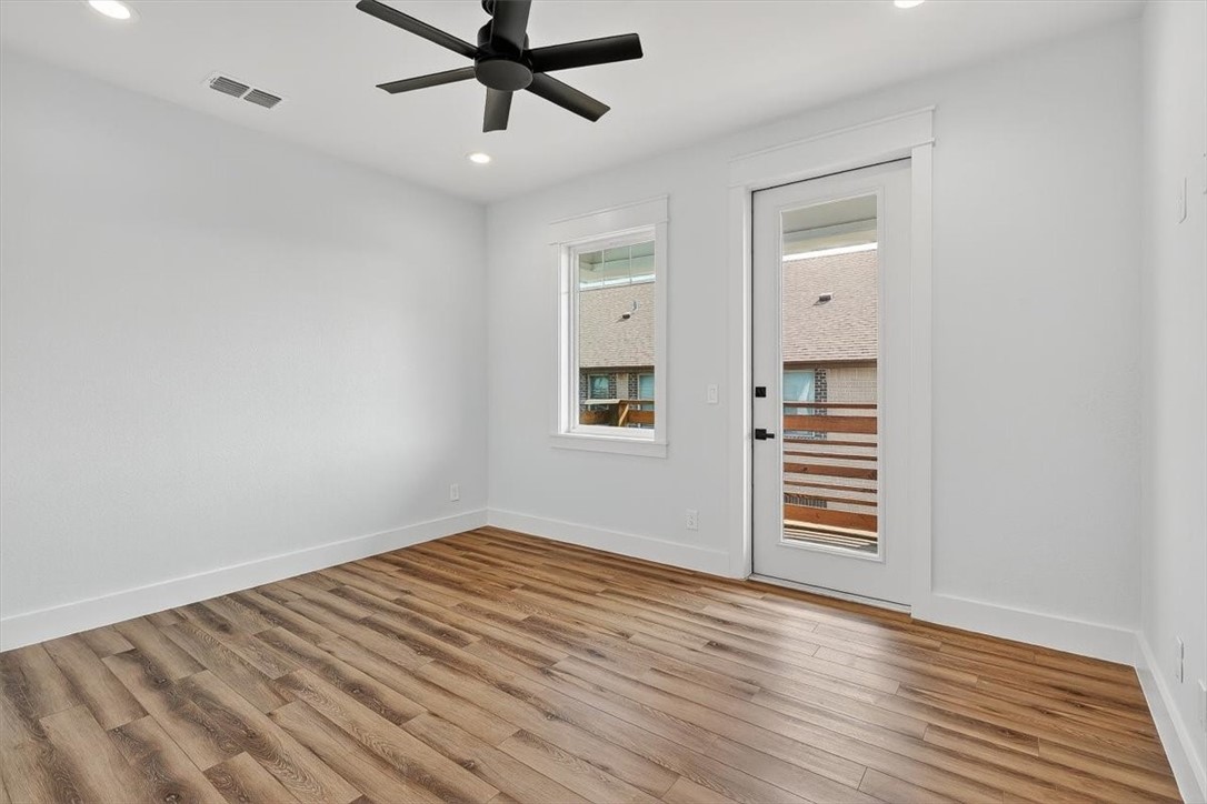 232 Nautilus Port Aransas, TX 78373 - Photo 23 of 28 a view of empty room with wooden floor and fan