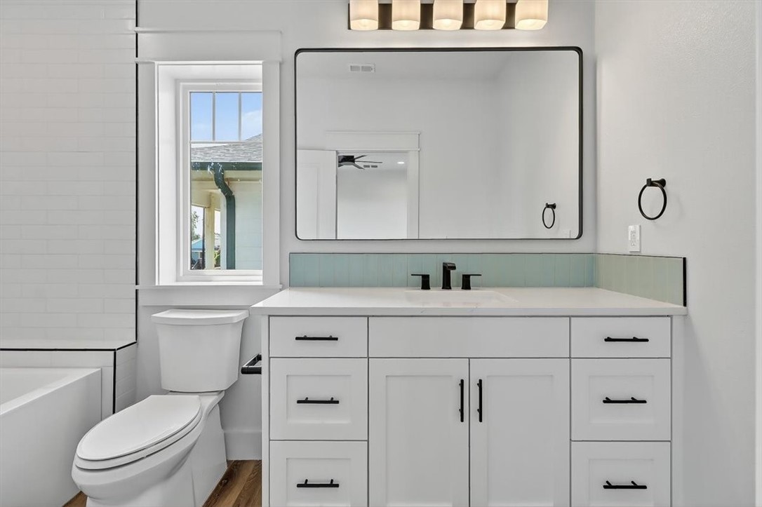 232 Nautilus Port Aransas, TX 78373 - Photo 25 of 28 a bathroom with a sink vanity mirror and toilet