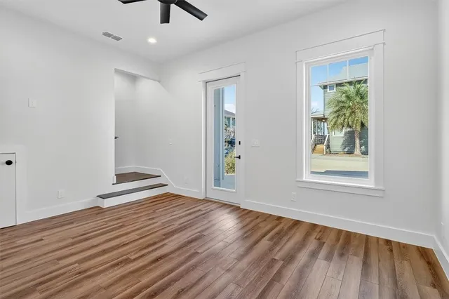 wooden floor in an empty room with a window
