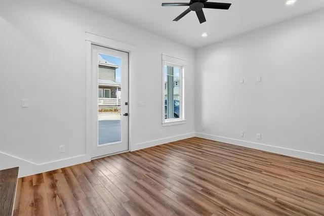a kitchen with a refrigerator a sink and wooden floor