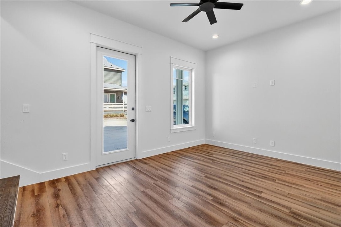 232 Nautilus Port Aransas, TX 78373 - Photo 8 of 28 wooden floor in an empty room with a window