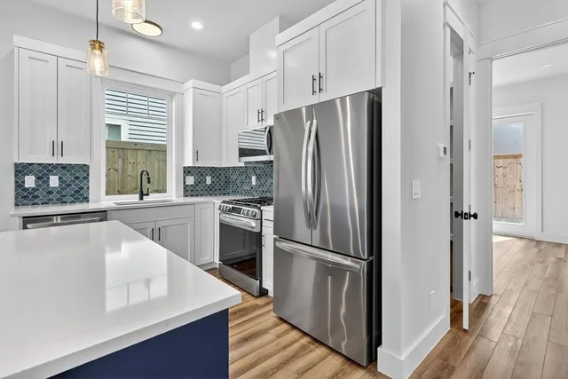 a kitchen with a sink stove and cabinets