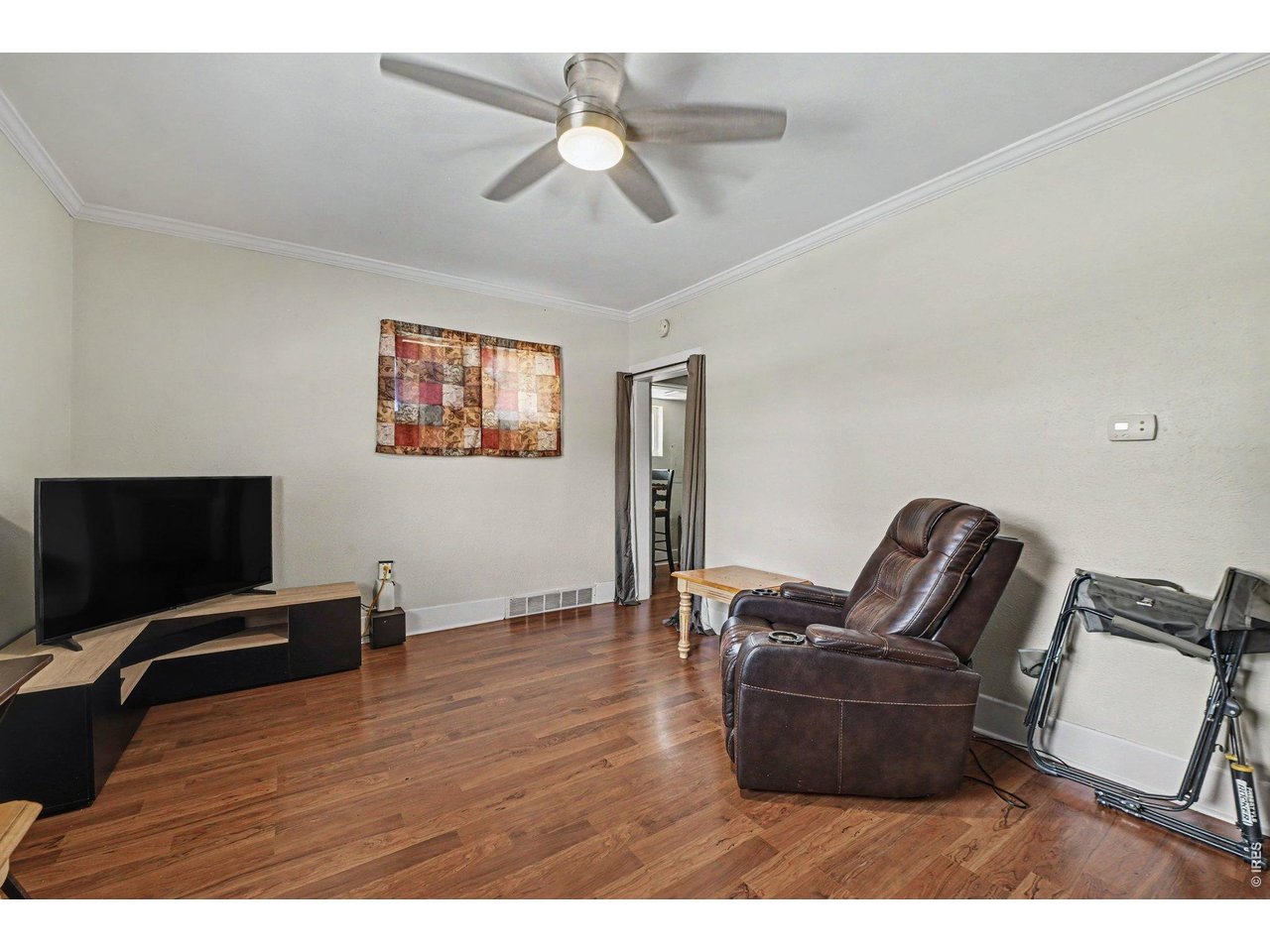 427 9th Street Greeley, CO 80631 - Photo 6 of 22 a living room with furniture and a flat screen tv