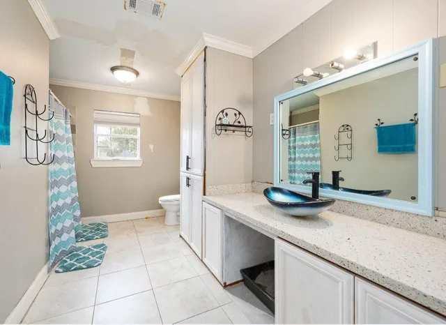 a spacious bathroom with a granite countertop sink and a mirror