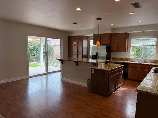 a kitchen with granite countertop a stove and a sink