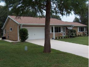 a front view of a house with a garden and yard