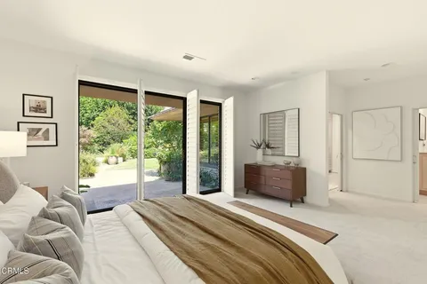 a bedroom with a large bed and a large window