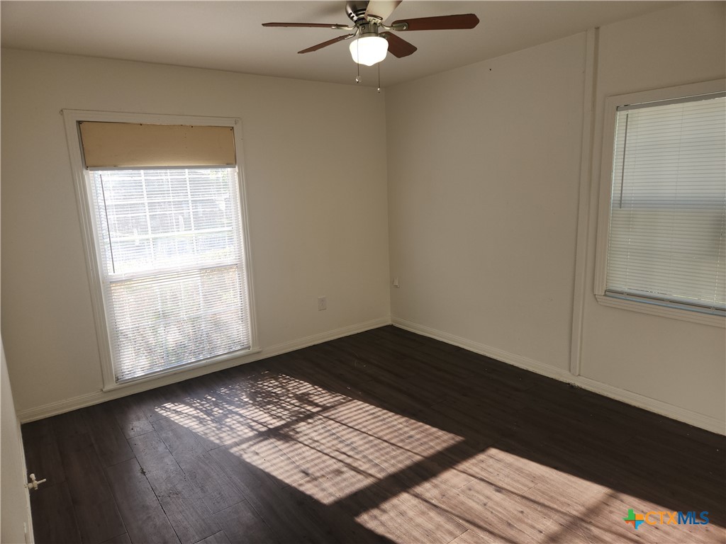 902 South 23rd Street Temple, TX 76504 - Photo 6 of 8 a view of wooden floor and a chandelier fan in a room