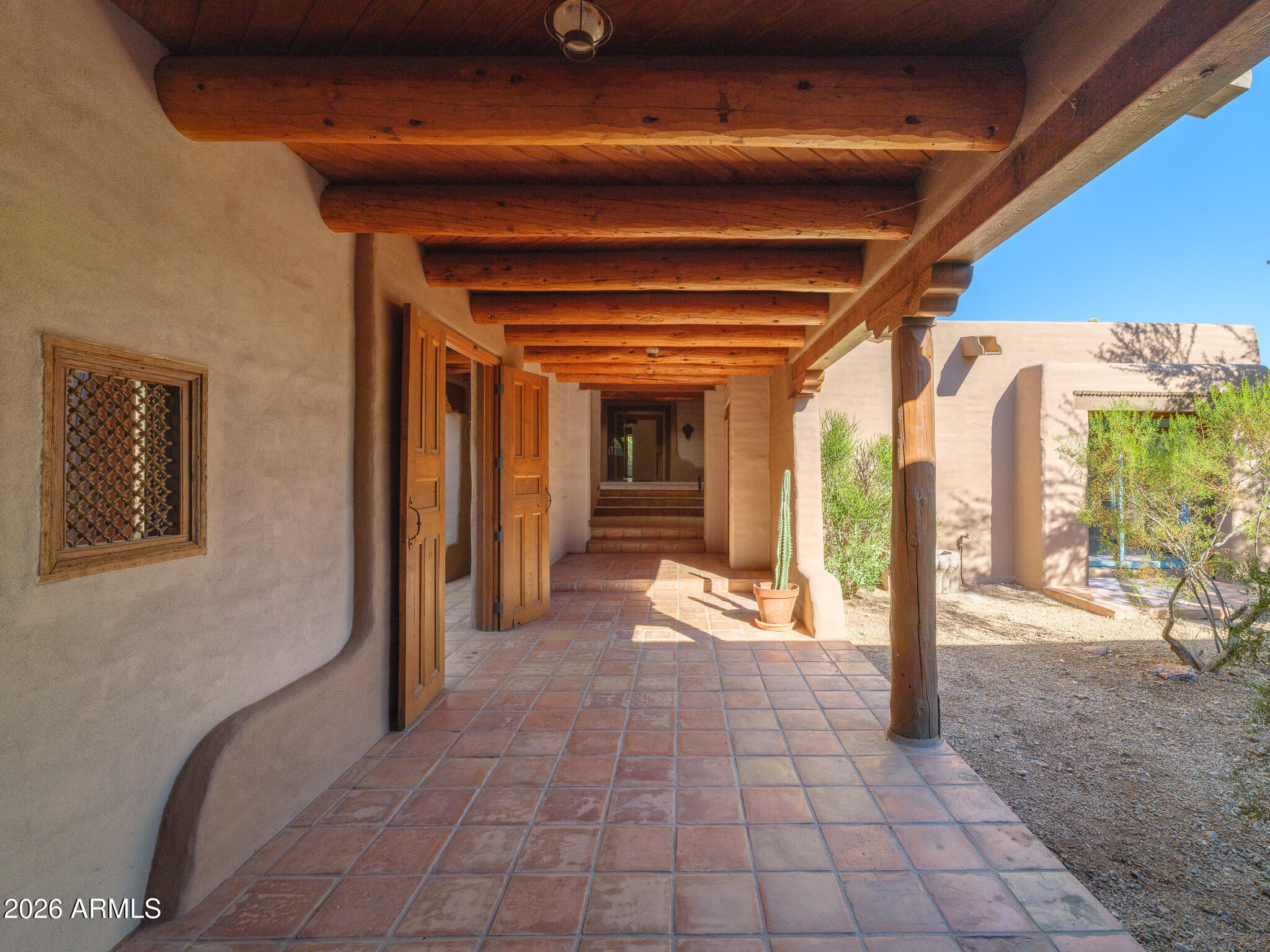 5507 North Palo Cristi Road Paradise Valley, AZ 85253 - Photo 13 of 41 a view of a hallway with wooden floor and a fireplace
