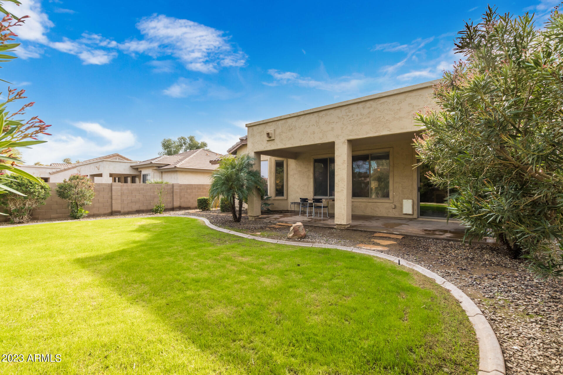 15348 West Calavar Road Surprise, AZ 85379 - Photo 26 of 28 a view of a patio with table and chairs under an umbrella