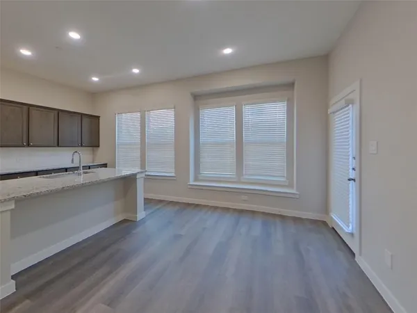 a kitchen with stainless steel appliances granite countertop a sink a refrigerator and a stove