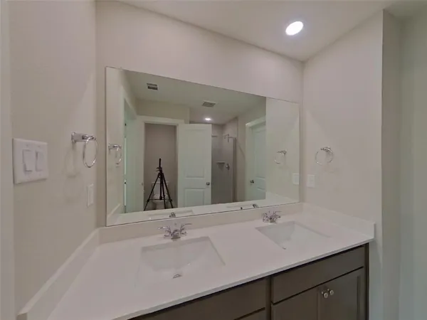 a bathroom with a glass shower door