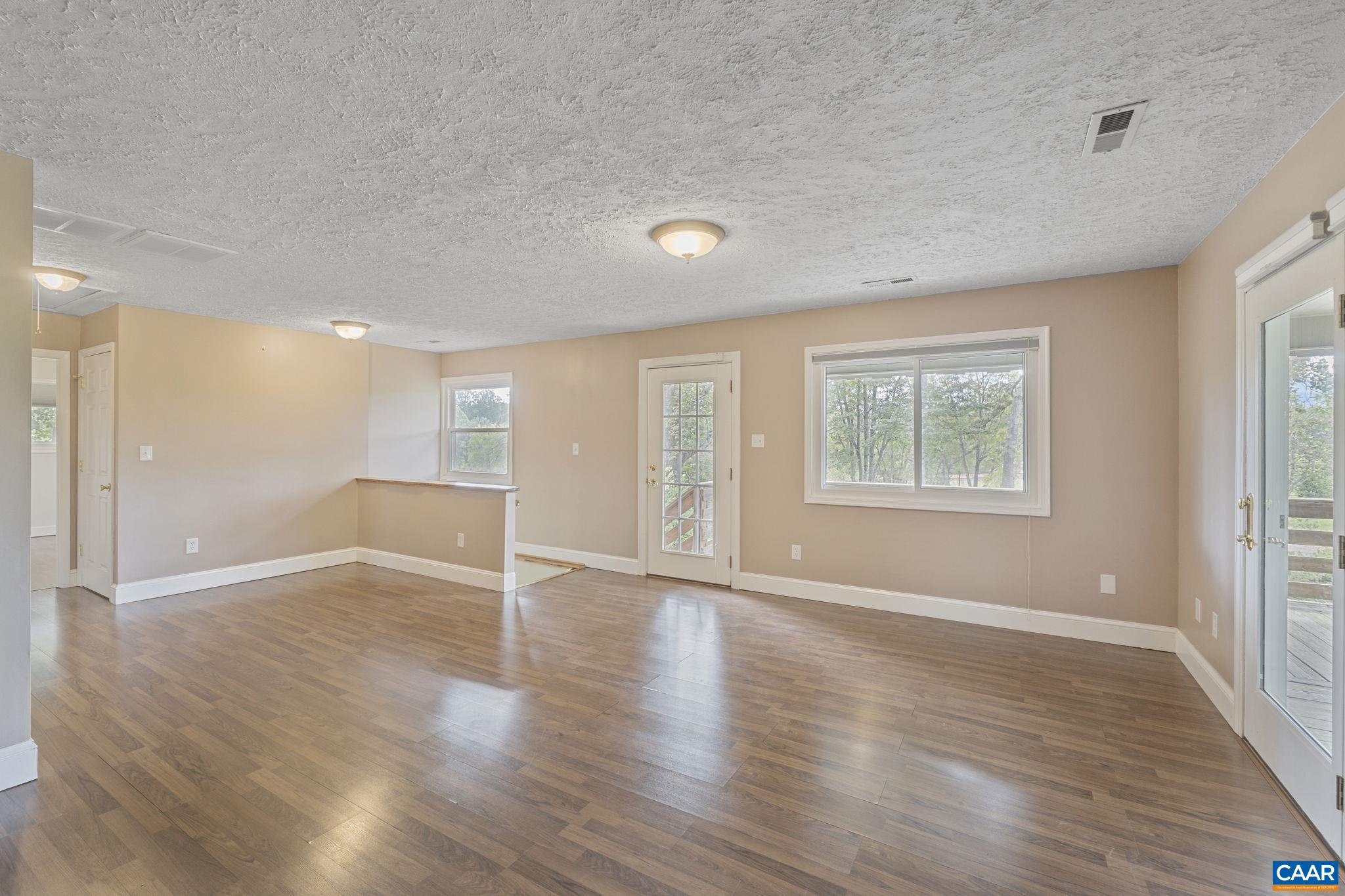 8508 Dick Woods Road Afton, VA 22920 - Photo 13 of 55 an empty room with wooden floor and windows