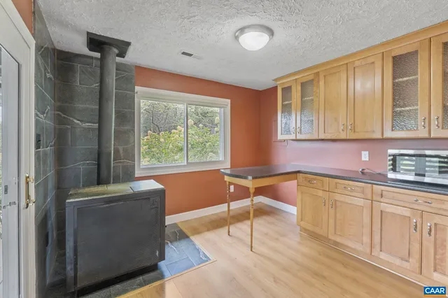 a spacious bathroom with a granite countertop tub sink and mirror