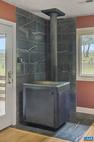 a view of a kitchen with kitchen island a sink a table and chairs