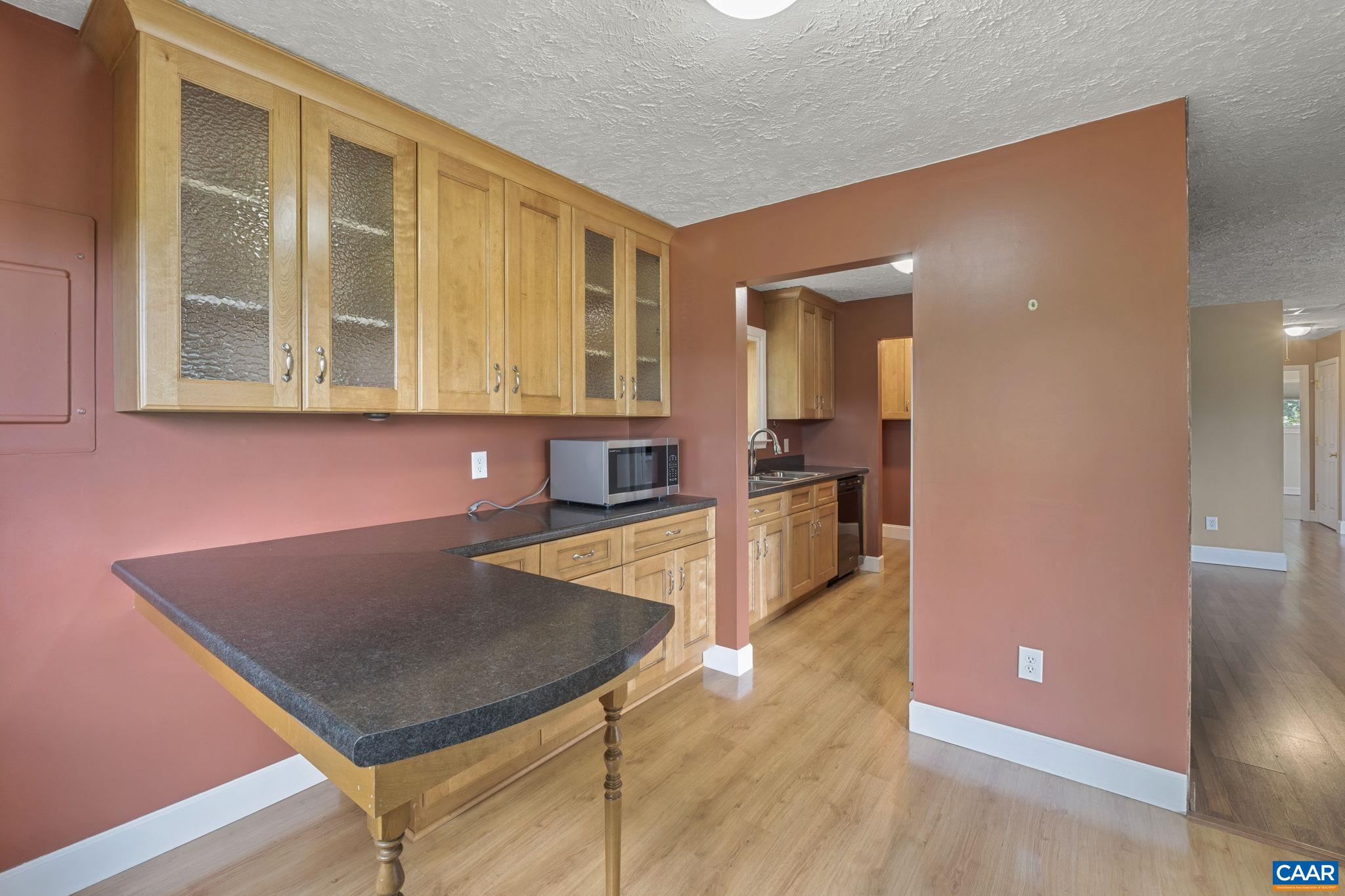 8508 Dick Woods Road Afton, VA 22920 - Photo 17 of 55 a view of a kitchen with kitchen island a sink a table and chairs