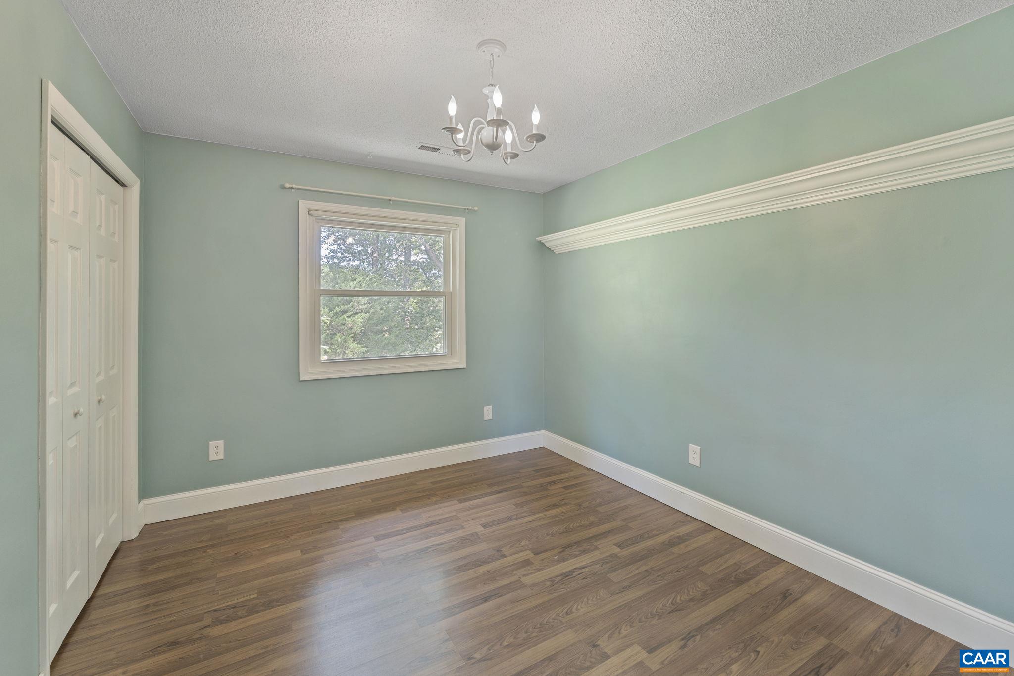 8508 Dick Woods Road Afton, VA 22920 - Photo 23 of 55 a view of a room with wooden floor and chandelier