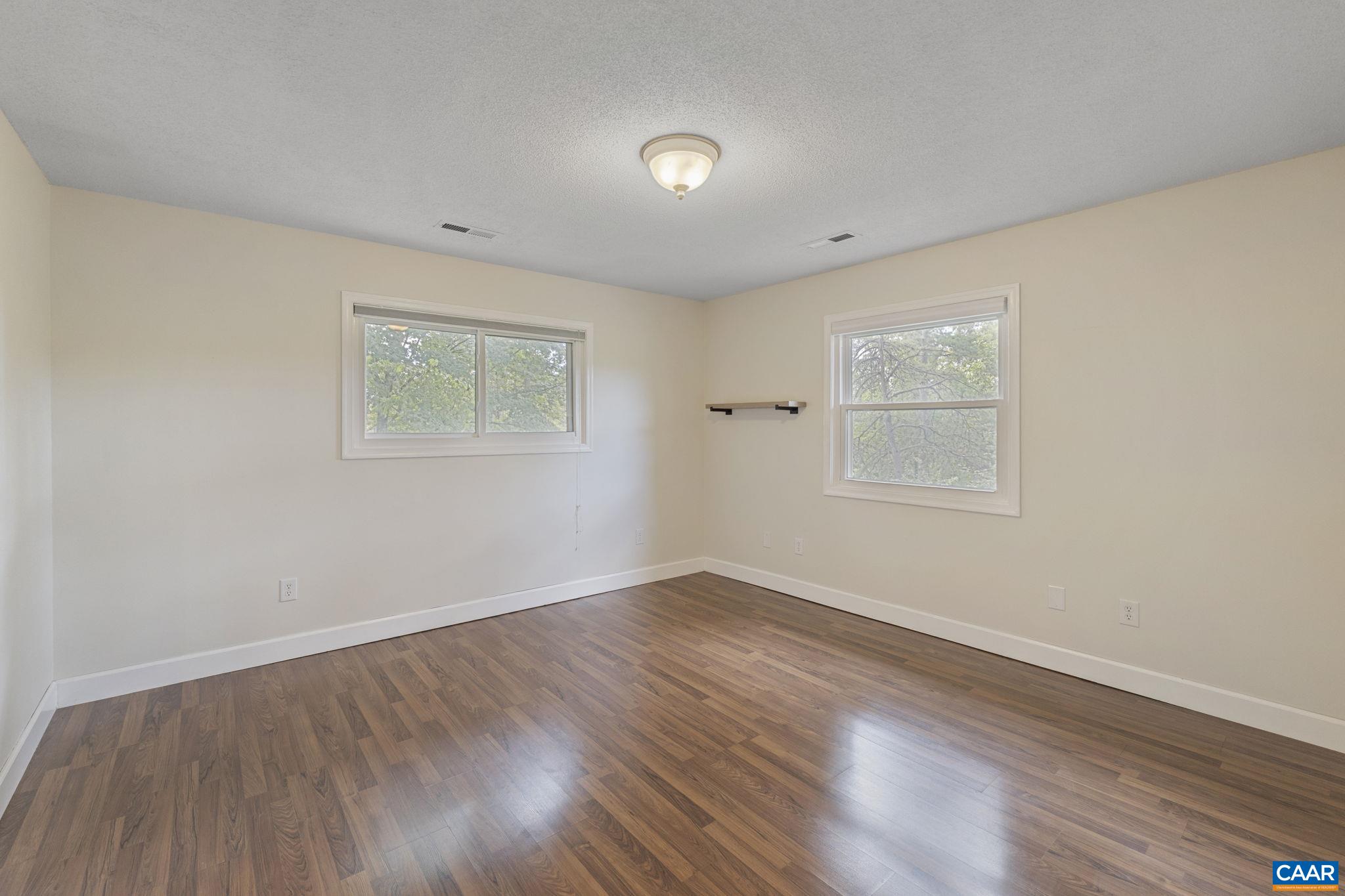 8508 Dick Woods Road Afton, VA 22920 - Photo 24 of 55 an empty room with wooden floor and windows