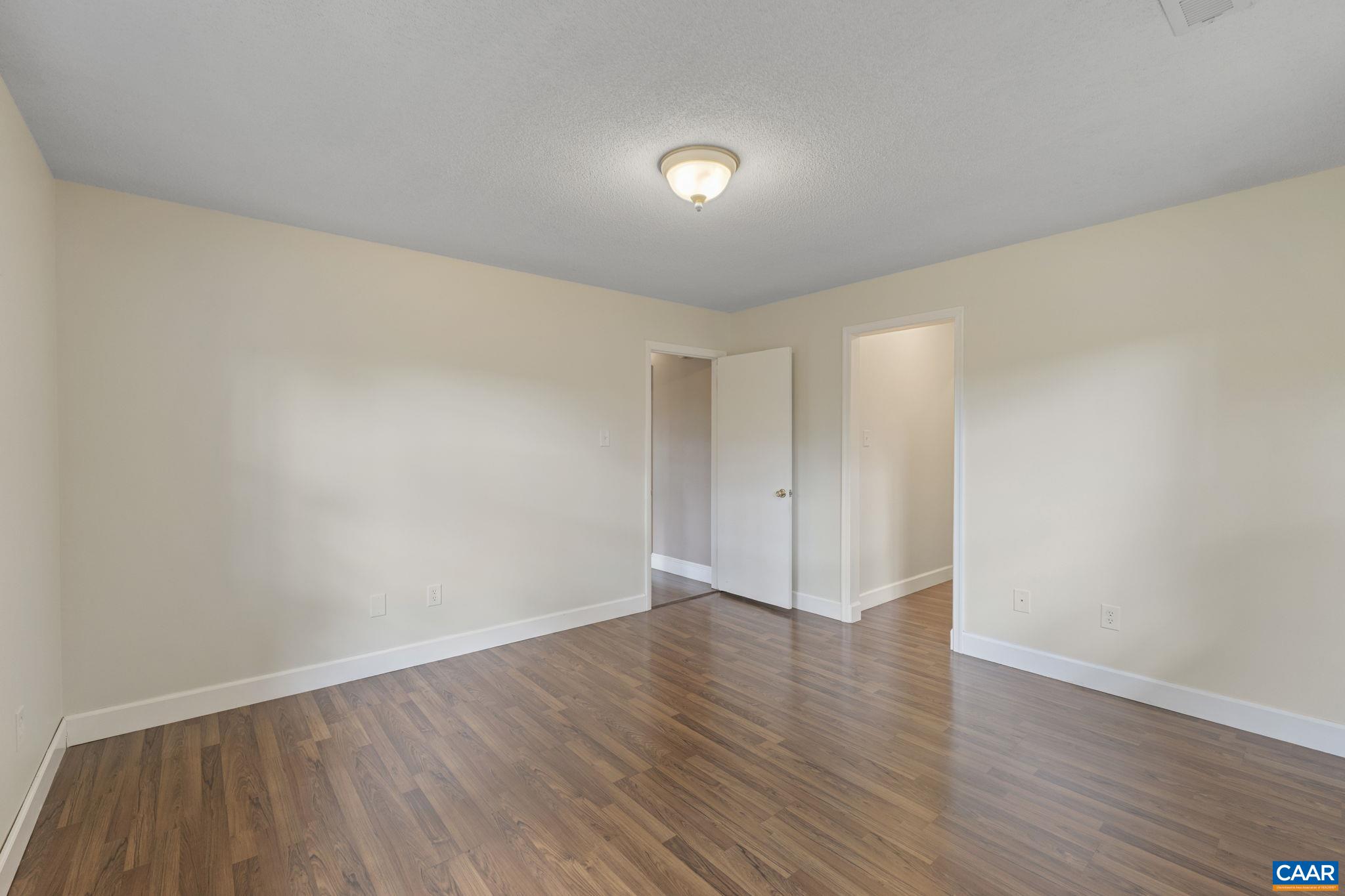 8508 Dick Woods Road Afton, VA 22920 - Photo 26 of 55 a view of an empty room with wooden floor and closet