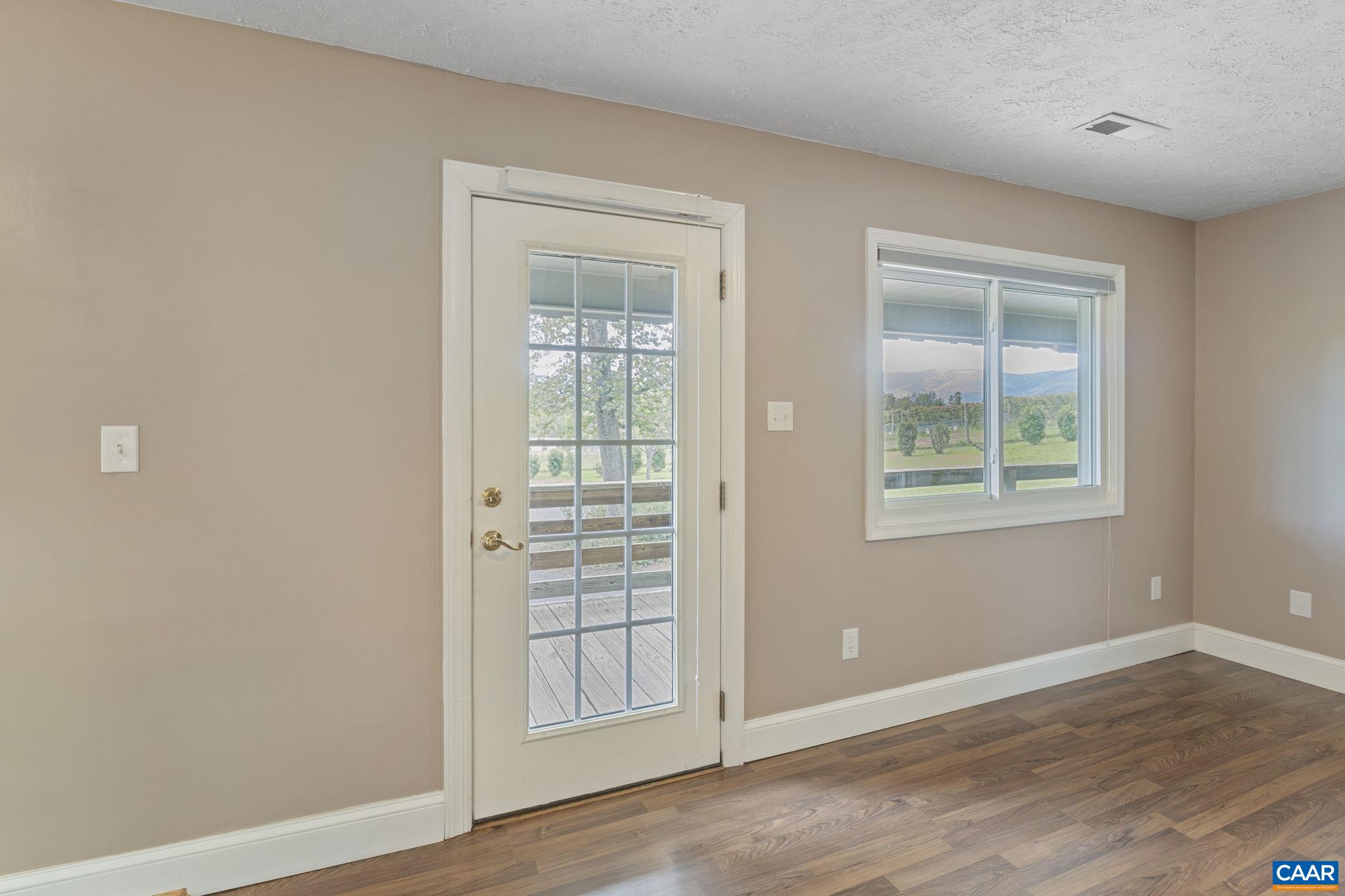8508 Dick Woods Road Afton, VA 22920 - Photo 7 of 55 an empty room with wooden floor and windows