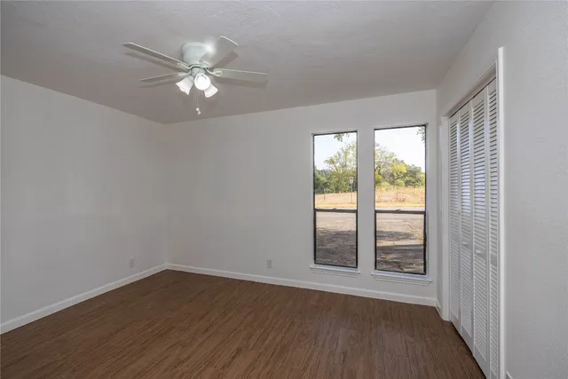 a view of wooden floor and windows in a room