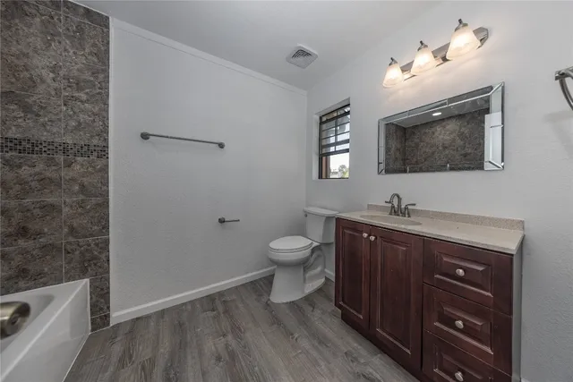 a bathroom with a toilet a sink and mirror
