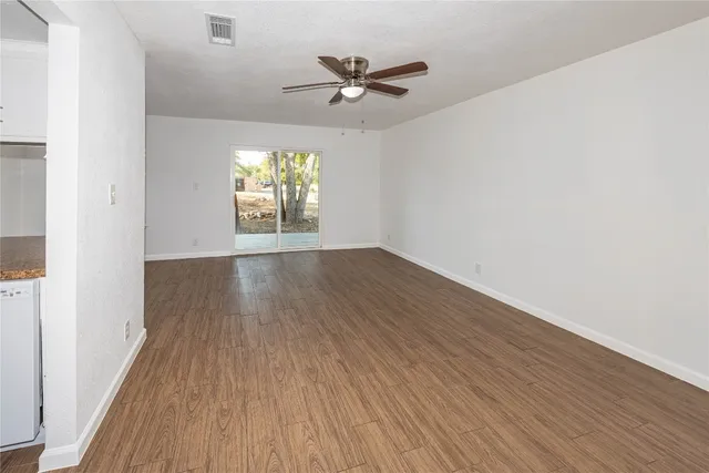 wooden floor in an empty room with a window