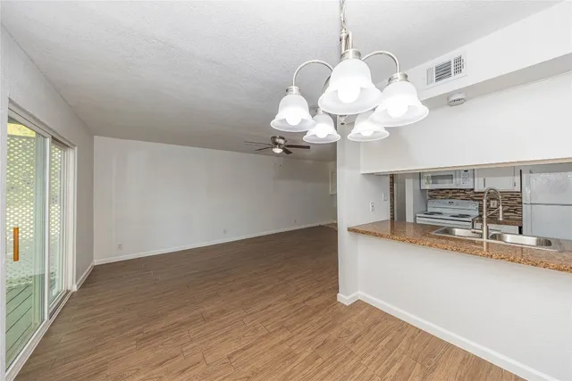 a view of a kitchen with a dishwasher and wooden floor