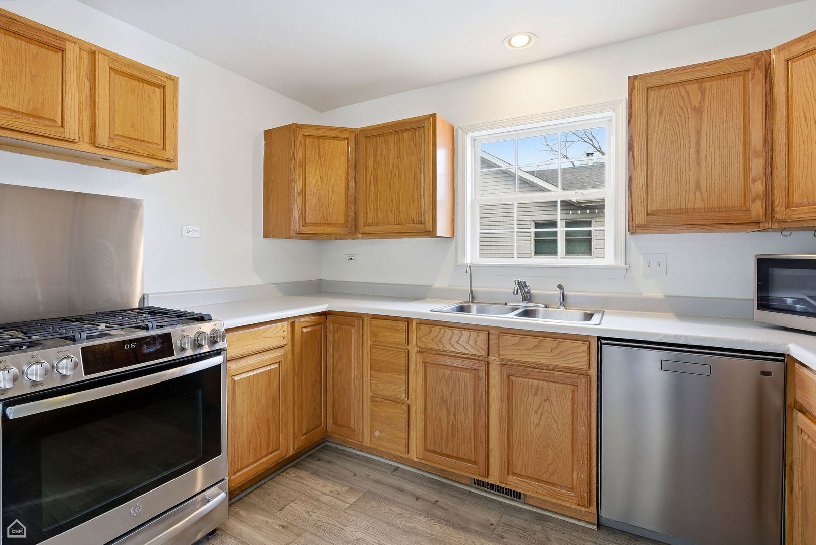 27071 North Ridge Street Wauconda, IL 60084 - Photo 11 of 36 a kitchen with granite countertop a stove sink and cabinets