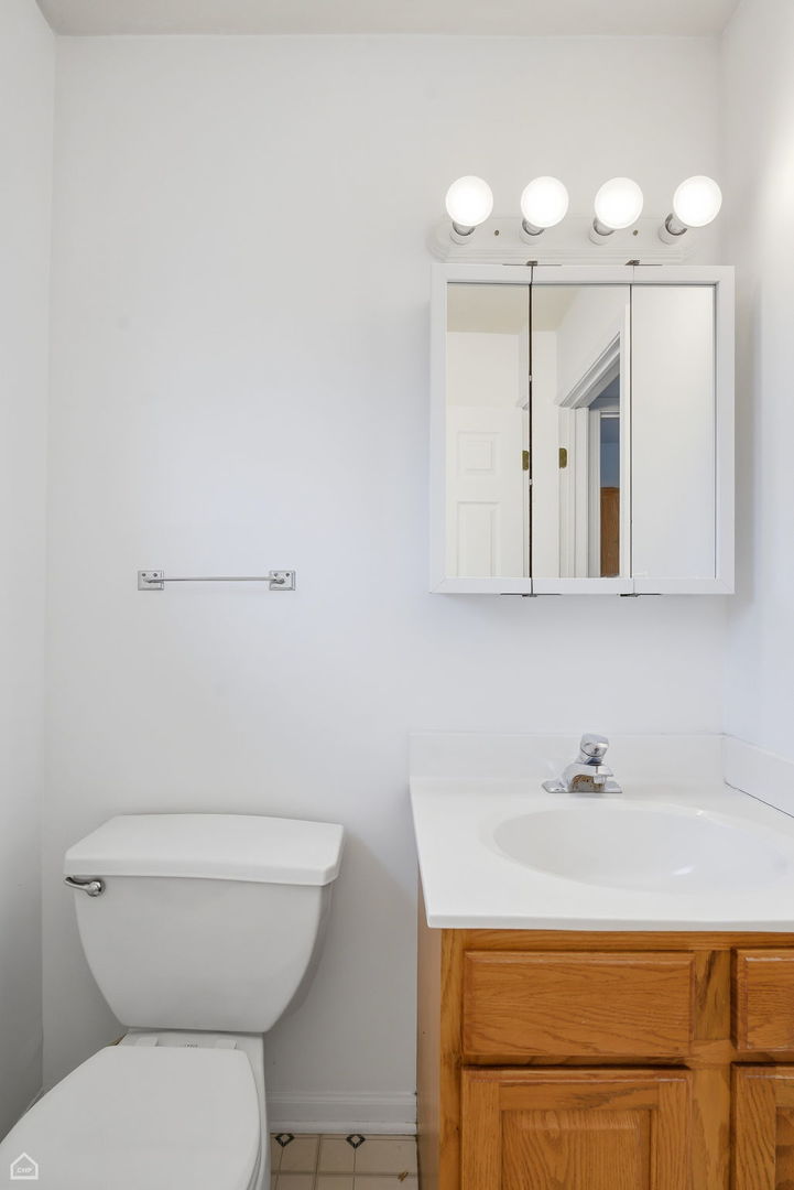 27071 North Ridge Street Wauconda, IL 60084 - Photo 13 of 36 a bathroom with a sink a toilet and a mirror