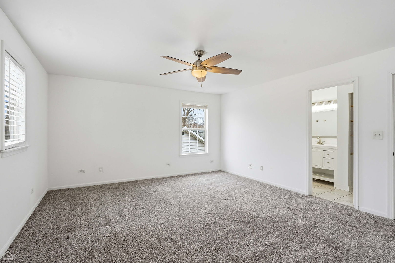 27071 North Ridge Street Wauconda, IL 60084 - Photo 17 of 36 an empty room with chandelier fan and windows