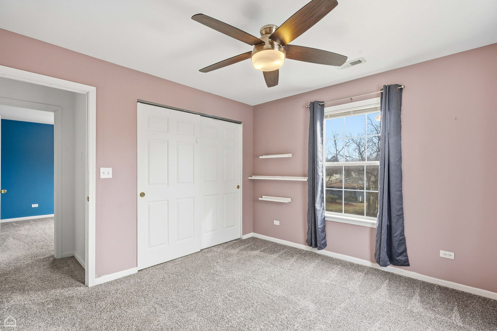 27071 North Ridge Street Wauconda, IL 60084 - Photo 21 of 36 an empty room with ceiling fan and windows