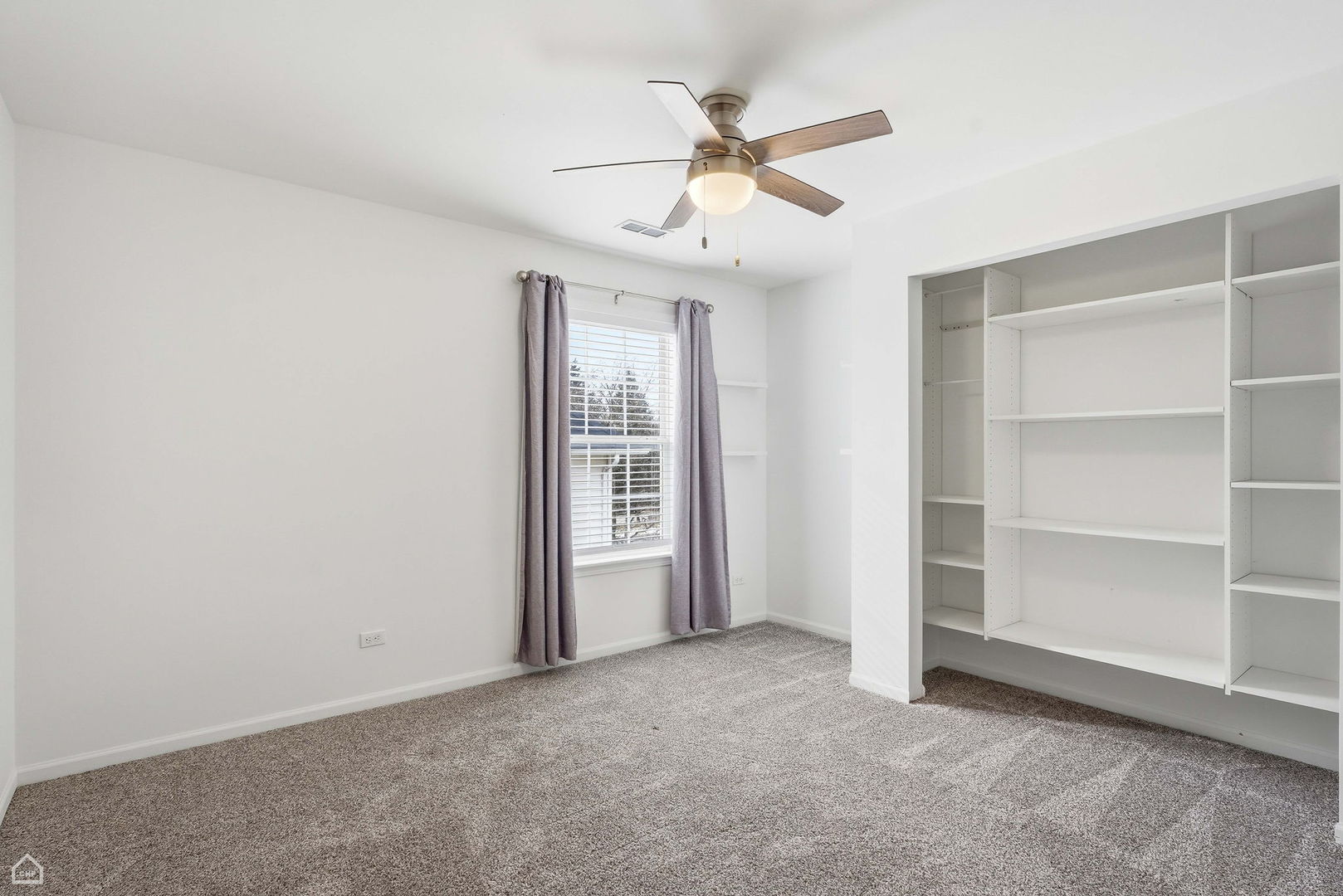 27071 North Ridge Street Wauconda, IL 60084 - Photo 24 of 36 an empty room with closet fan and windows