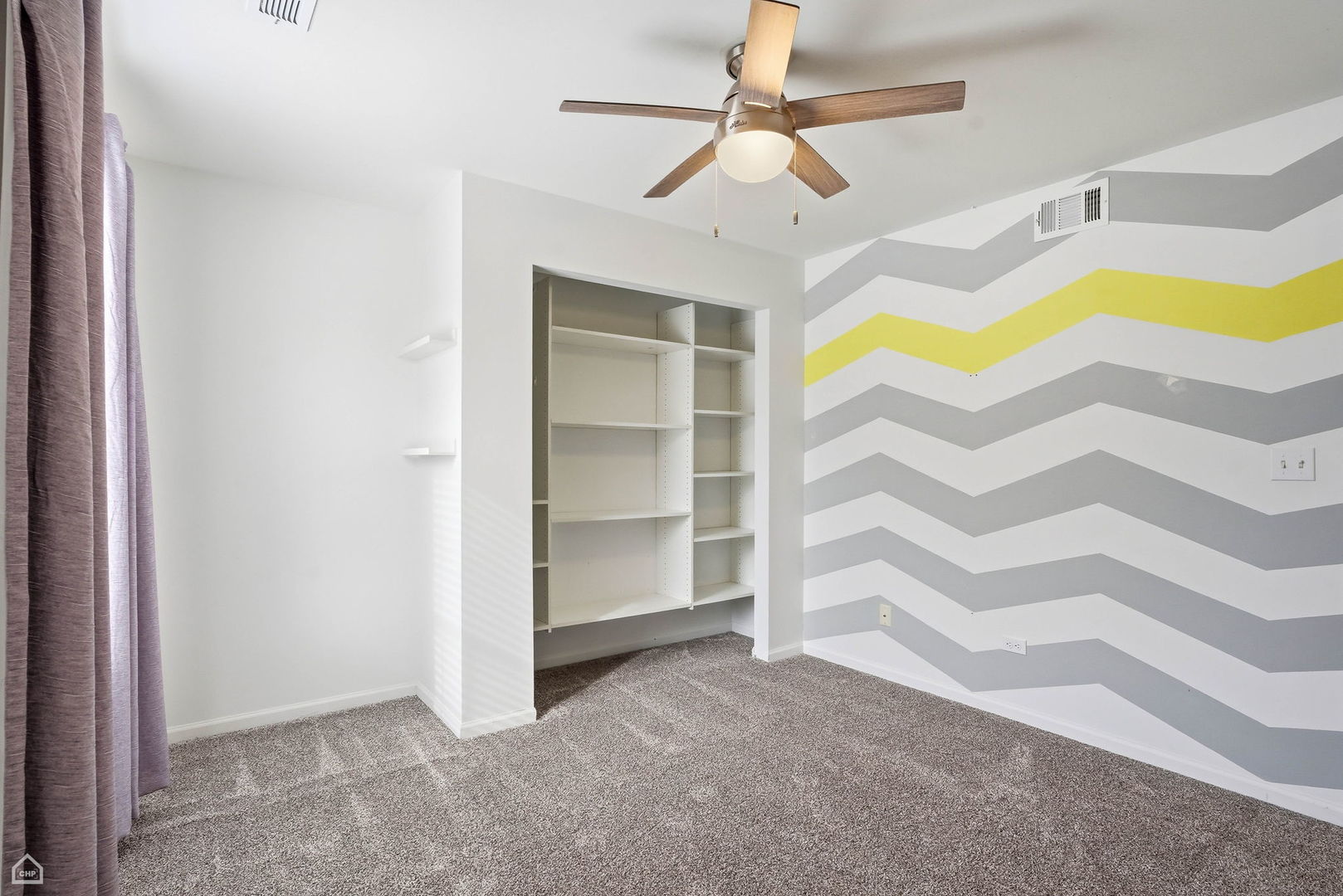 27071 North Ridge Street Wauconda, IL 60084 - Photo 25 of 36 an empty room with a ceiling fan and a window