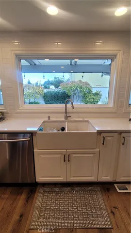 a kitchen with a sink and large window