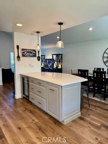a view of a kitchen counter space a stove and wooden floor