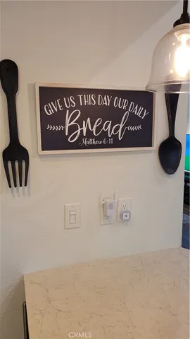 a large kitchen with a table chairs refrigerator and microwave