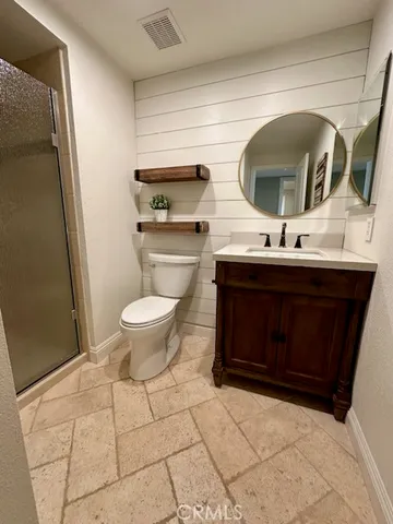 a spacious bedroom with a bed and a desk