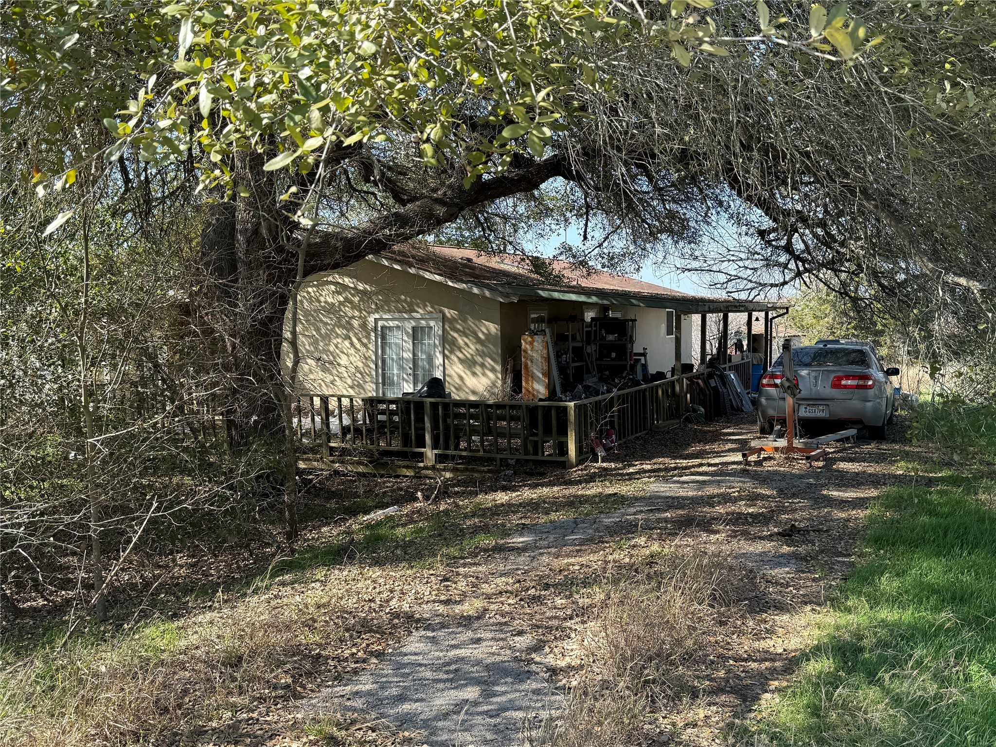 a view of a house with a tree on the road